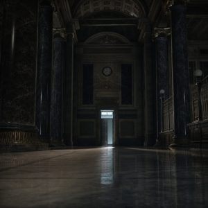 A vast vaulted hall inside an old financial institution late at night, long rows of dark polished stone columns receding into shadow, a single narrow doorway ahead with cool pale light spilling through it. Muted greys, aged brass and deep navy, one low-angle light source raking across a polished stone floor. Cinematic wide composition, shallow depth of field, quiet and institutional atmosphere.